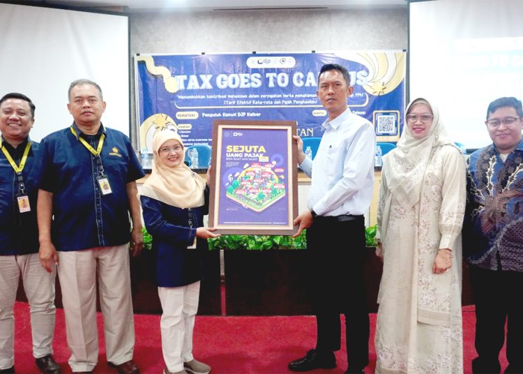 Dahlia Kepala Bidang Penyuluhan, Pelayanan dan Hubungan Masyarakat Kanwil DJP Kalimantan Barat menyerahkan poster Pemanfaatan Sejuta Uang Pajak kepada civitas akademika di FKIP Universitas Tanjungpura.(ist)