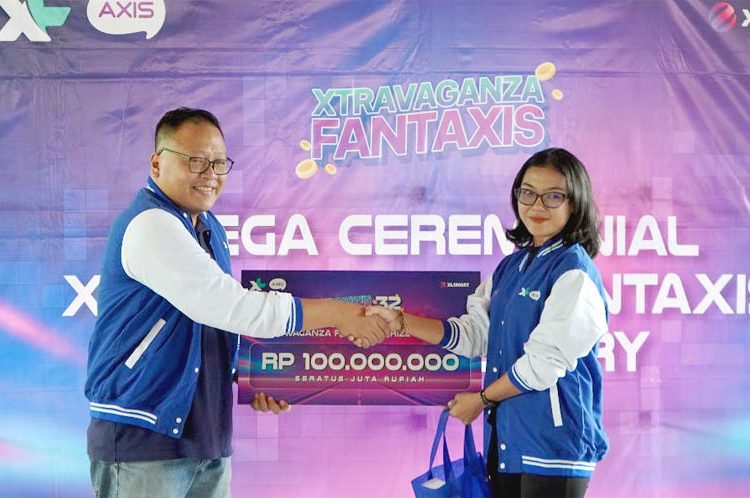 Head Growth & Loyalty XLSMART, Gustiano (kiri) menyerahkan hadiah Grand Prize VIP Program Xtravaganza/FantAXIS sesi ke-32 senilai Rp 100.000.000, kepada Kadek Wahyu Dwi Setiawati (Jakarta Timur), di Jakarta, Kamis. (ist)